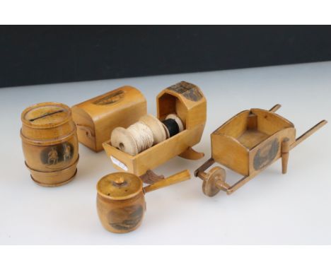 Five items of Mauchline Ware, to include moneybox, wheelbarrow, trunk, saucepan pincushion &amp; crib 
