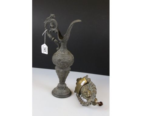 A victorian door knocker of classical form together with a cast metal ewer. 