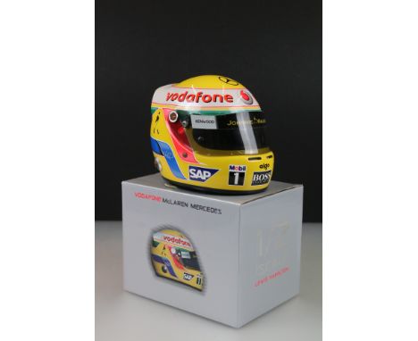 A collectable half scale Vodafone McLaren Mercedes Lewis Hamilton racing helmet with original box. 