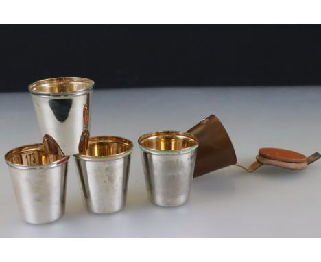 Set of Four German Stacking Stirrup Cups with harlequin enamel rims and gilt linings contained in a leather case 