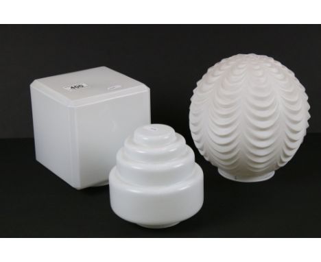 A collection of three white glass pendant lamp shades. 