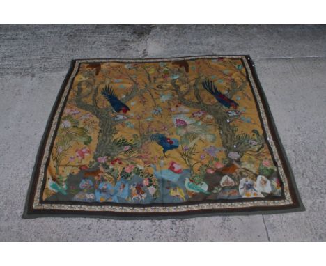 A large hanging tapestry of exotic birds with floral background. 
