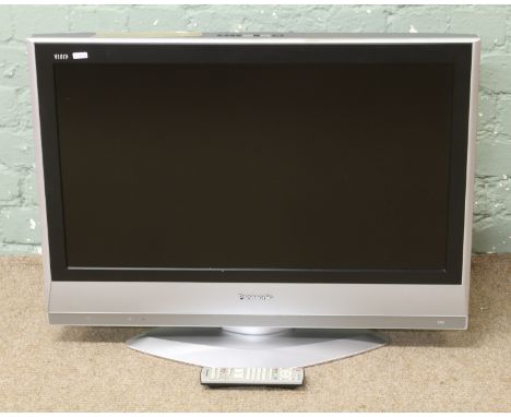 A Panasonic 32 inch flat screen television with instruction manual and remote control.