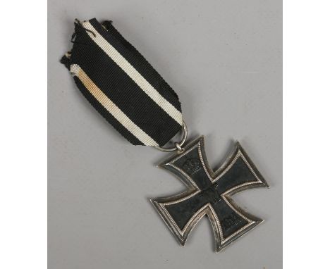 A World War I German iron cross and ribbon, makers stamp R.