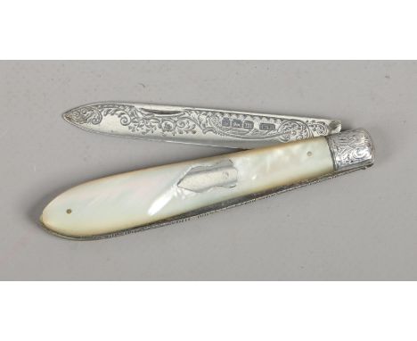 A silver fruit knife with mother of pearl scales and work back decoration assayed Sheffield 1904.