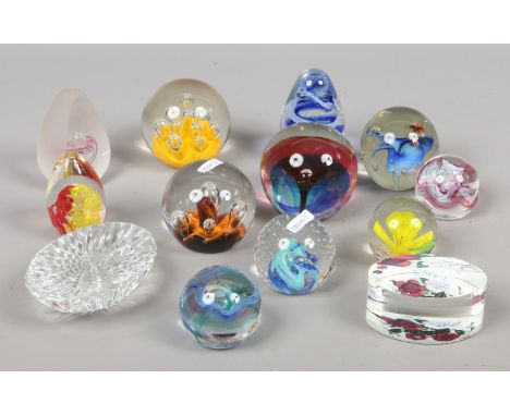 A collection of thirteen decorative glass paperweights to include Caithness examples.