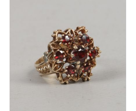 A yellow metal garnet snowflake cluster ring, size J.