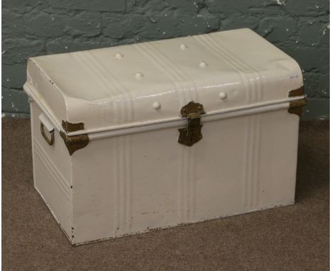 A painted cream vintage steel trunk.