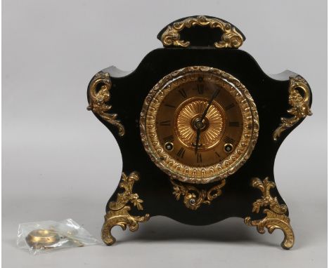 A Victorian ornate mantel clock with painted metal case, housing an Ansonia movement wit key and pendulum.