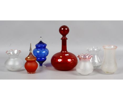 A collection of glasswares to include ruby glass decanter, oil lamp shades etc.