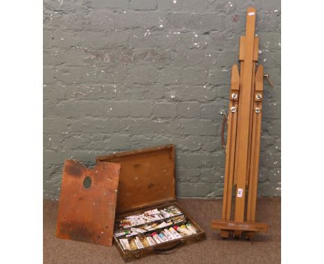 An artist folding easel by Mabef Italy and a carry box of oil paints and pallet.
