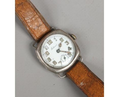 A vintage silver cased federal manual wristwatch with white enamel dial and subsidiary seconds.