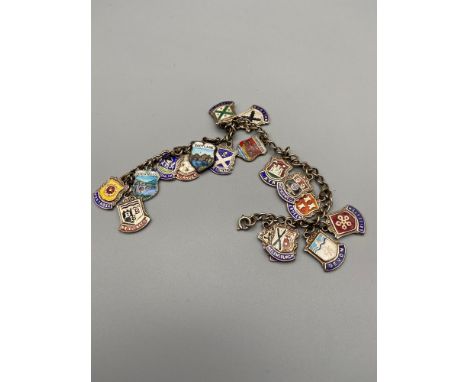 A Silver and enamel charm bracelet showing various names around Scotland. 
