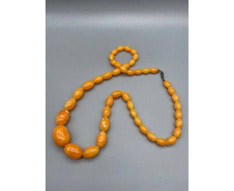 A Vintage Amber graduating bead necklace made from egg yoke/ Butter scotch Amber. [Weighs 61.6grams] 