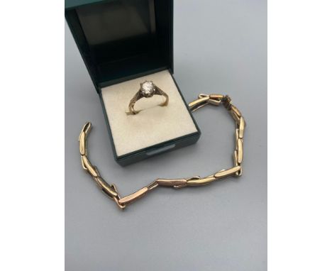 A Gold on Silver ladies ring set with a large clear stone. Together with a gold on silver watch strap. 