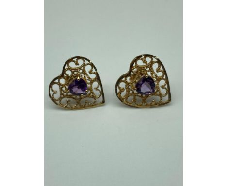 A Pair of 9ct gold heart shaped earrings set with a heart shaped amethyst stone centre. [Weighs 1.41 grams] 