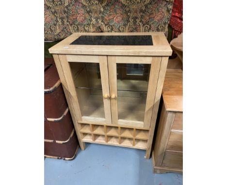 A Contemporary light wood drinks cabinet fitted with interior lighting and marble top. 