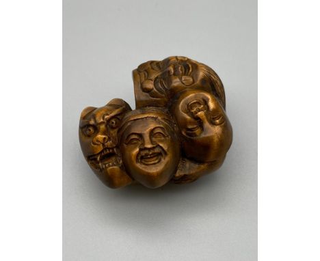 Japanese hand carved netsuke of seven various masks. Signed by the artist. [4.5cm length] 