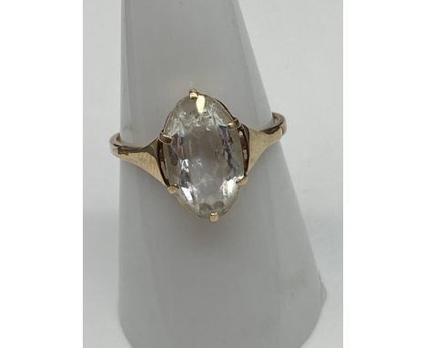 An Antique ladies 9ct gold ring set with a large clear glass stone. [Weighs 2.21 grams] [Ring size P] 