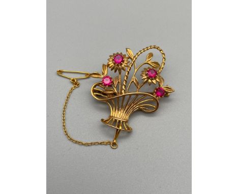 A High grade gold [18-24ct unmarked] Basket of flower design brooch set with four large ruby stones [stone 3.5mm] [6grams] 
