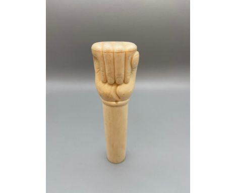 A Japanese Meiji period bone carved clenched fist walking stick handle. Signed by the artist. [13cm length] 