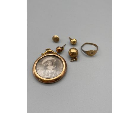 A Lot of Gold which includes A Victorian 9ct gold mourning pendant, 9ct football charm, A Pair of 9ct gold earrings, 9ct gold