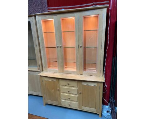 A contemporary light wood ercol display cabinet fitted with glass shelf interior and lighting. [210x141x50cm] 