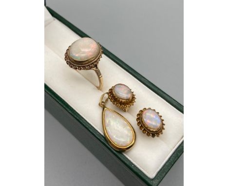 A Ladies 9ct gold ring set with a large opal stone, a pair of 9ct gold and opal stone earrings and a 9ct gold and large opal 