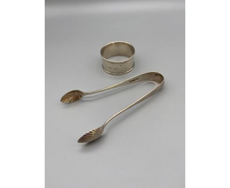 A Pair of Birmingham silver sugar tongs made by Thomas Hayes and dated 1891 together with a Chester silver napkin ring dated 