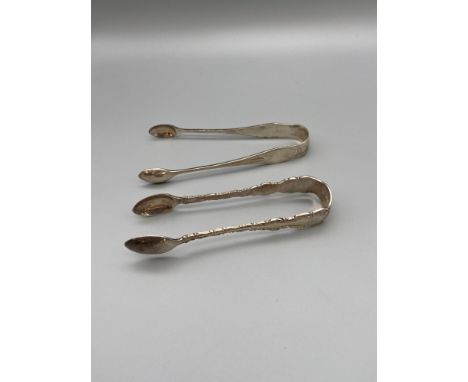 Two pairs of Sheffield silver sugar tongs. Art deco style set is made by James Dixon &amp; Sons Ltd and dated 1919, ornate se