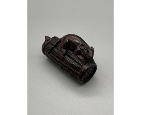 A Japanese hand carved netsuke of two mice on a basket. Signed by the artist. 
