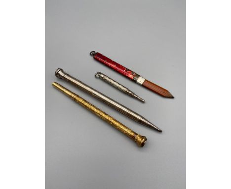 A Lot of four vintage revolving pencils which includes a rare [possibly gold] Mordan &amp; Co highly detailed engraved revolv