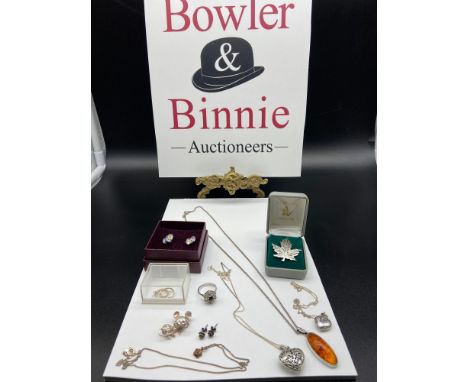 A Lot of silver jewellery which includes Silver and amber pendant with silver chain, Sterling silver Canadian leaf brooch, Si