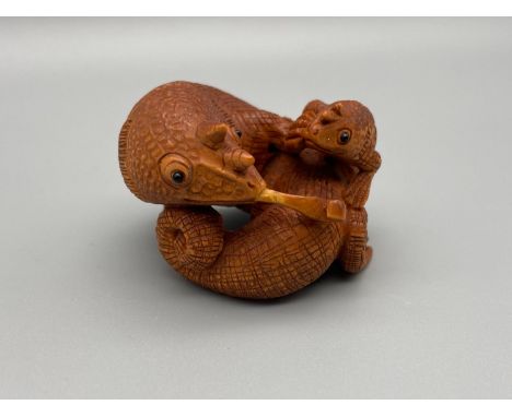 A Hand carved Japanese netsuke of large Cameleon and baby Cameleon. Both detailed with black bead eyes. [Slight crack in tong