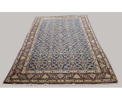 CENTRAL IRANIAN RUG,  probably Veramin, circa 1940, the mid indigo field with an all over Herati design enclosed by aubergine