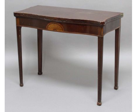 MAHOGANY AND CROSSBANDED SERPENTINE CARD TABLE, 19th century,the shaped top and sides above a central patera and canted, tape