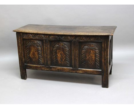 ELM COFFER, 18th century, the two plank cover with pin hinges above a three panel front with arched carving, height 70cm, wid