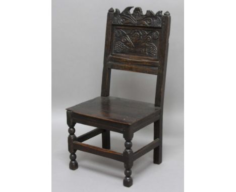 OAK BACK STOOL, late 17th century and later, the floral carved top rail above a scrolling floral panel, solid seat, blacka nd