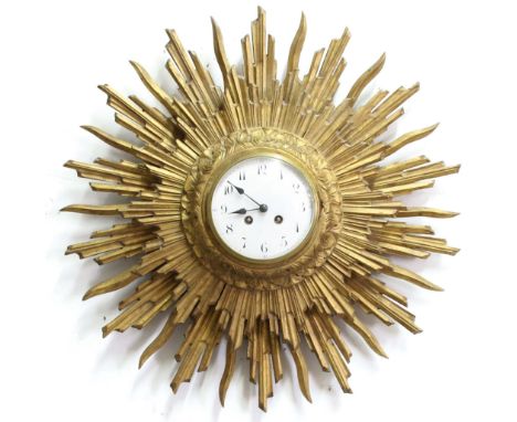 FRENCH GILTWOOD SUNBURST WALL CLOCK,  late 19th or early 20th century, the 5" enamelled dial on a brass, eight day movement b
