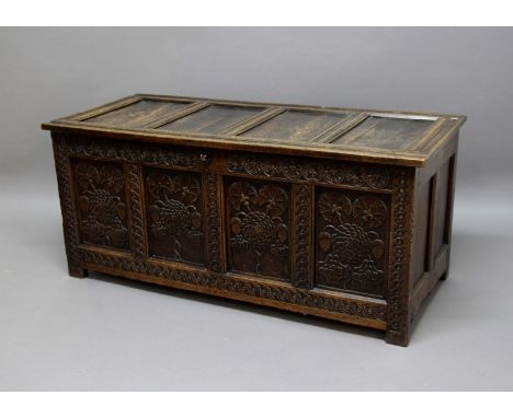 OAK COFFER,  18th century, the four panelled top with candle box interior above a four panel front with meandering floral car