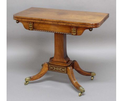 REGENCY ROSEWOOD AND BRASS INLAID CARD TABLE, the rounded rectangular, hinged and twisting top above a rectangular section co