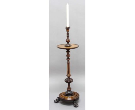 VICTORIAN CANDLESTAND, probably rosewood, the baluster turned candlestick above a tray, turned and carved column, circular ba