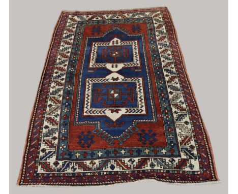 FACHRALO RUG,  Central Caucasus, circa 1910, the madder field with central double niche panel containing twin hooked devices 