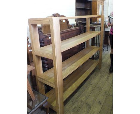 A modern four tier light Oak effect shelving unit