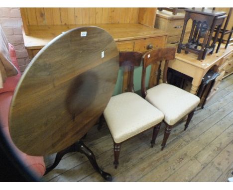 A Georgian Mahogany circular snap top tripod table and a pair of 19th Century Mahogany bar back chairs