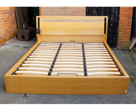 A nearly new kingsize bed frame and mattress with light fitting to head board and matching TV stand