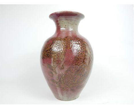 A Chinese stoneware pottery vase, hand painted with dragons on a red ground, having impressed Chinese stamp, and a London sta