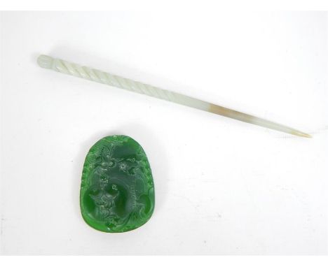 A Chinese green jade hairpin with a carved, twisted top and finial (Length: 20 cm), with a green carved pendant (6 x 4.5 cm).