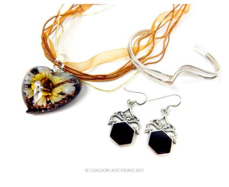 A collection of jewellery including a Murano glass heart necklace, a sterling silver bangle and a pair of silver earrings wit