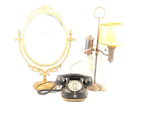 Cast brass table mirror, oval plate, 56cm; vintage TTR bell telephone; pewter oil lamp; two similar spelter figures of a clas